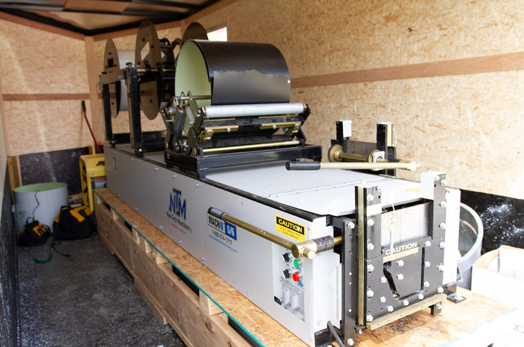 portable seamless gutter machine inside box truck