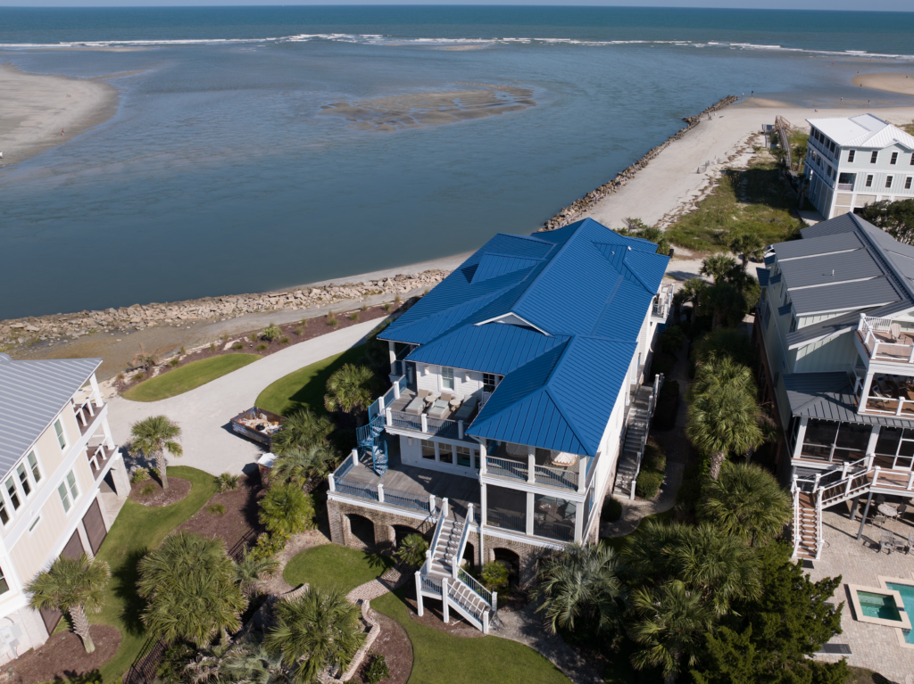 Drone shot of a blue metal roof on an apartment building on the Atlantic coastline.