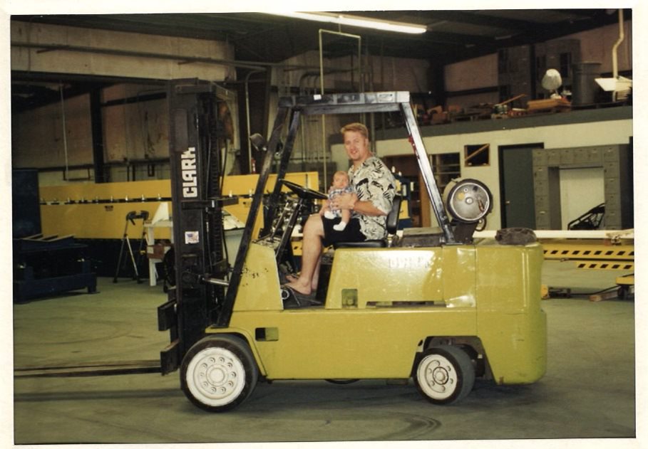 Todd Andrews and his son Preston as a small child on a forklift.