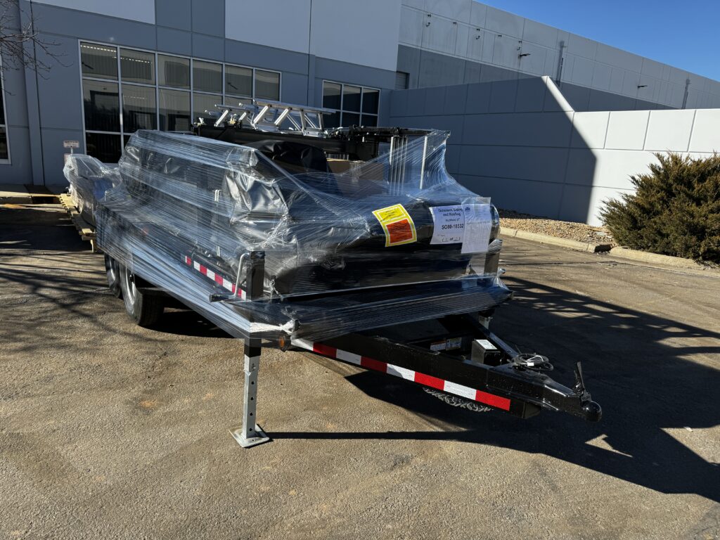 Rollforming machine on a trailer, wrapped for delivery.