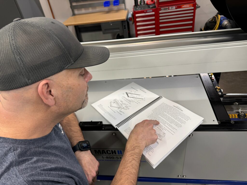 A man reading an NTM machine manual.