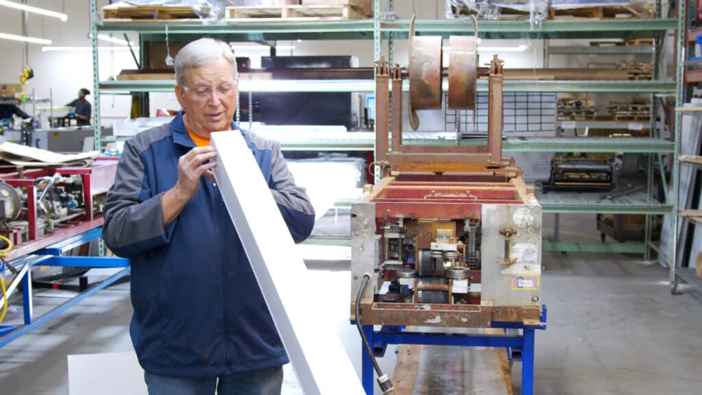 Ron checking a piece of gutter produced by NTM's first gutter machine