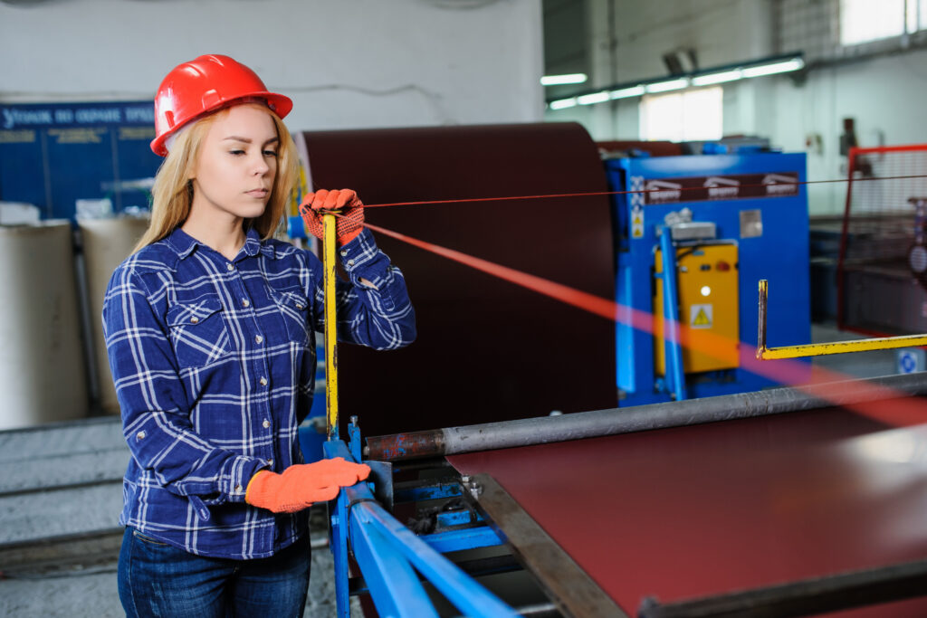 Worker examining rollforming process
